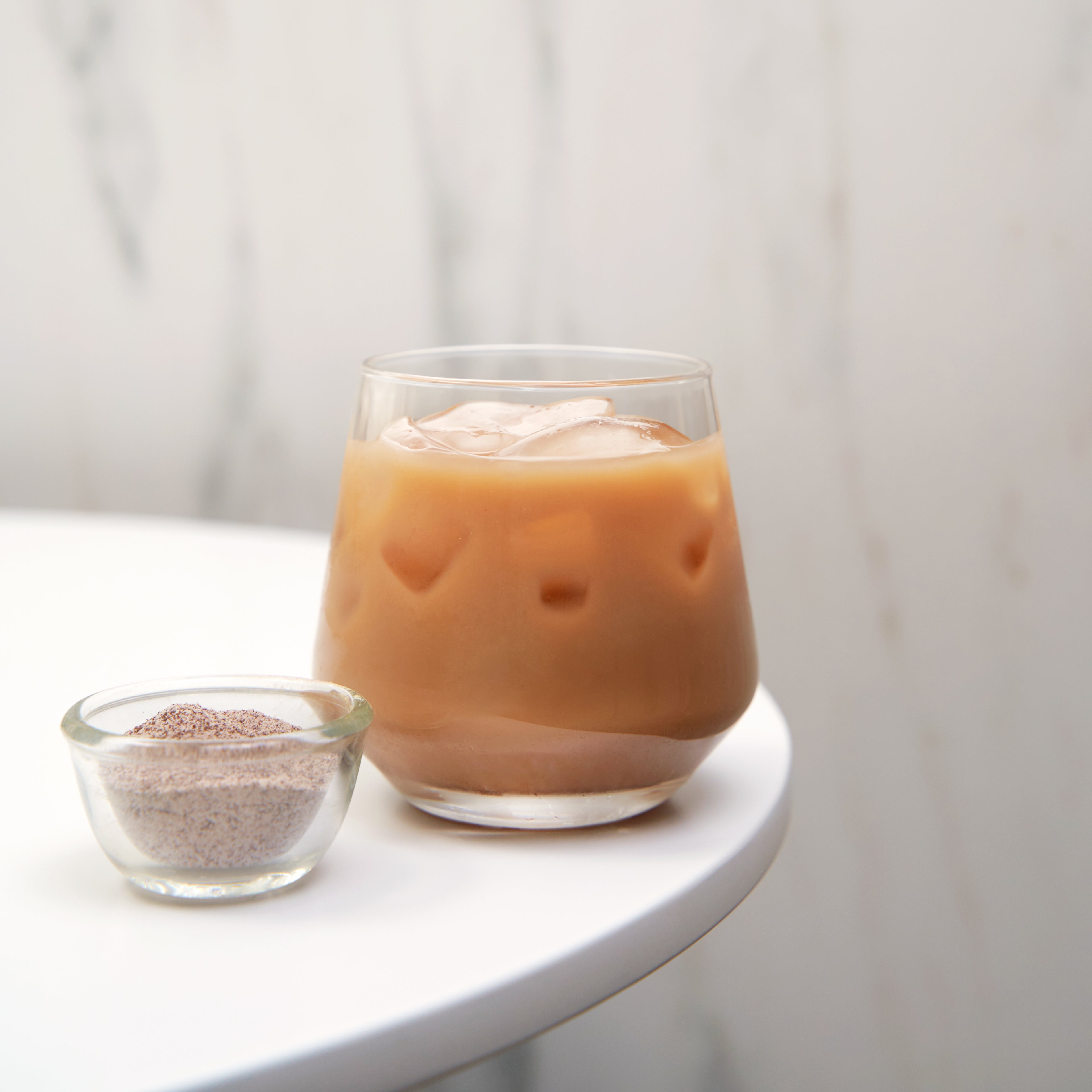 A glass of iced mocha coffee made with Hojalicious powder, demonstrating a smooth, creamy texture and appetizing appearance.