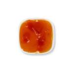 Close-up of mango jam texture, featuring rich fruit puree and pulp with a bright orange, natural preserve consistency.