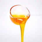 Close-up of pineapple concentrated syrup pouring, showcasing a golden bright texture with rich tropical aroma.