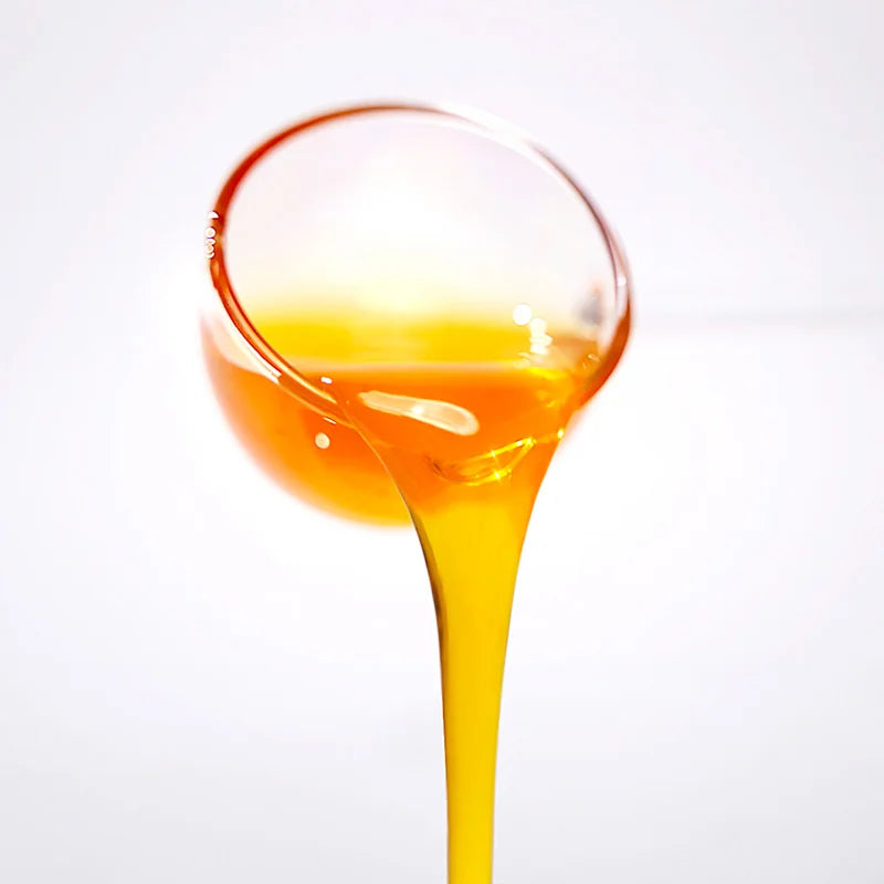 Close-up of pineapple concentrated syrup pouring, showcasing a golden bright texture with rich tropical aroma.