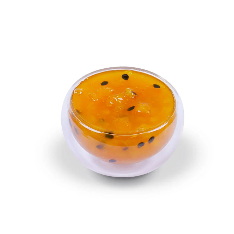 Close-up of tropical fruit jam texture, featuring rich fruit puree with real fruit pieces and seeds for a natural preserve consistency.