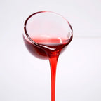Close-up of professional hibiscus concentrated syrup pouring, showing deep ruby red color and viscous texture for bubble tea and cocktails.