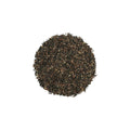 Close up of fine-cut dark brown Red Pu Erh Tea leaves for espresso extraction.